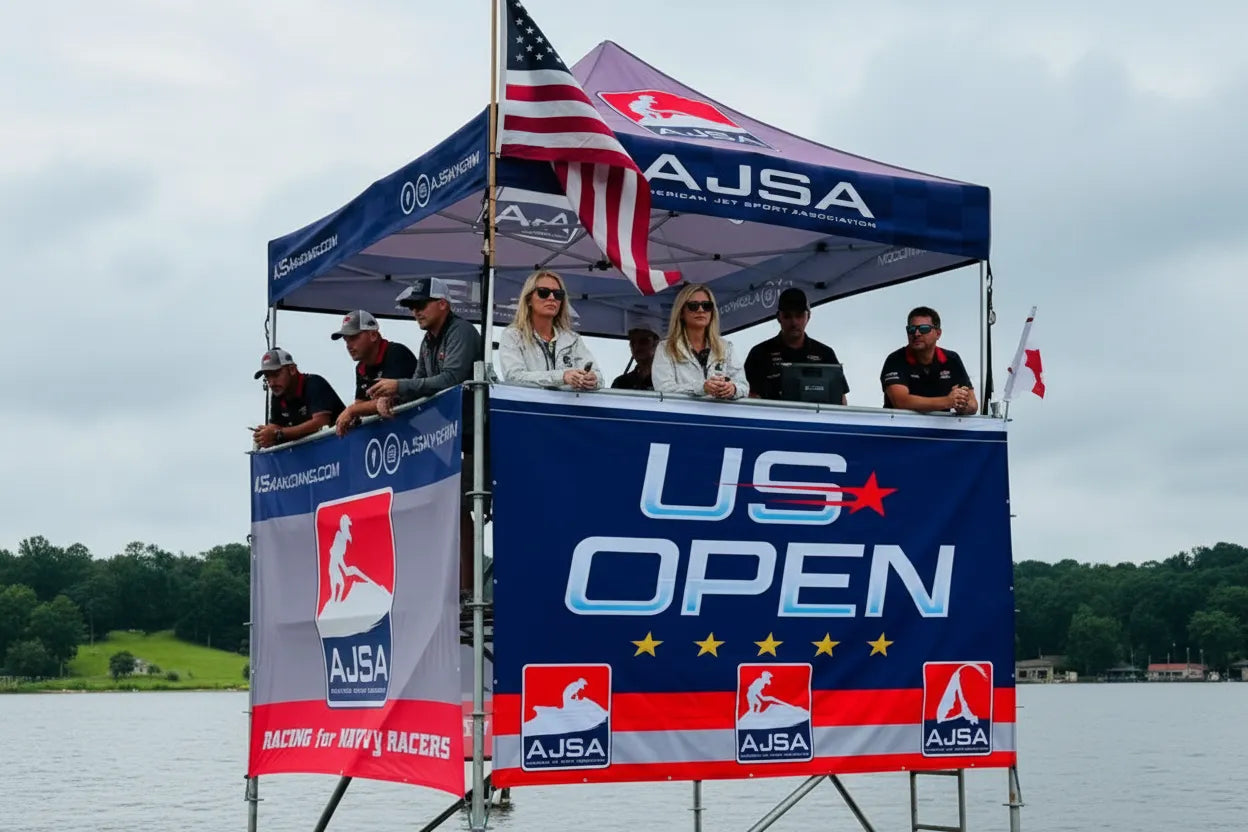 Custom AJSA branded tower canopy tent with officials at a jet ski racing event